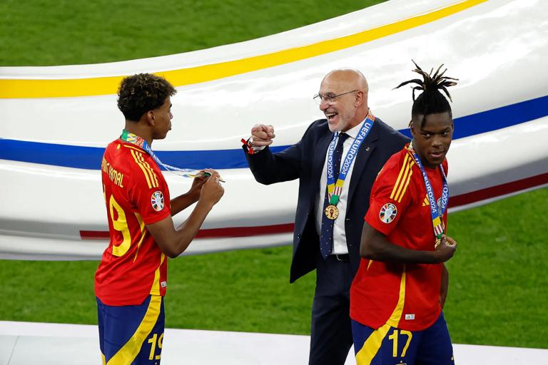 Spain's head coach Luis de la Fuente celebrates with Spain's midfielder #17 Nico Williams and Spain's forward #19 Lamine Yamal after winning the UEFA Euro 2024 final football match between Spain and England at the Olympiastadion in Berlin on July 14, 2024. (Photo by Odd ANDERSEN / AFP) (Photo by ODD ANDERSEN/AFP via Getty Images)
